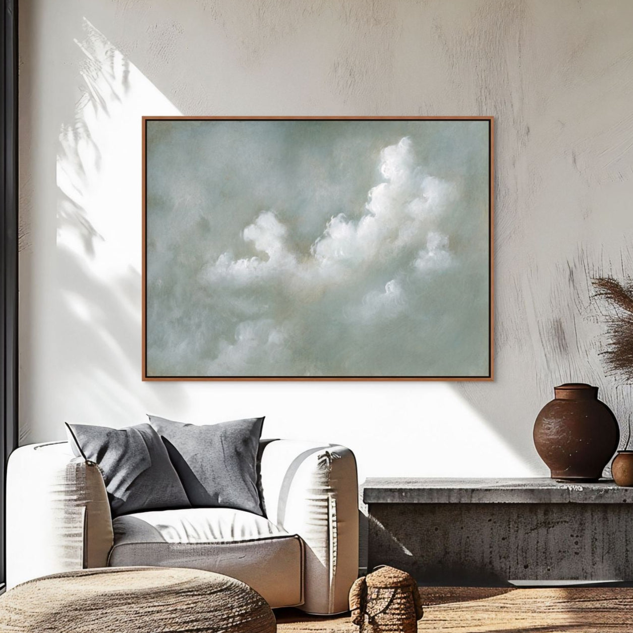 Modern living room with a white sofa, wooden armchair, and decorative items.