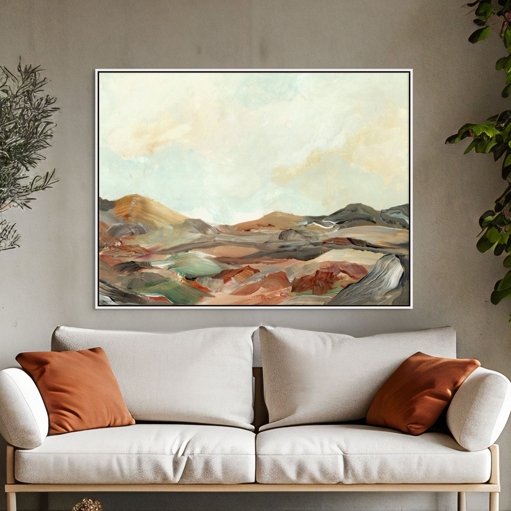 Modern living room with a white sofa, decorative pillows, and a landscape painting on a wall.